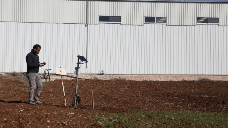 A technician from the Optosmart company, a partner of the project, examines the field in the Bekaa valley, in Lebanon, where they will install the sensors for the new irrigation system being developed. (Image: Georges Abi Aad/UKLTH)