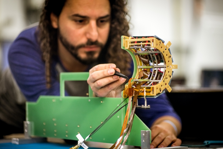 Andres Delannoy is shown working on one of the four cassettes of the Pixel Luminosity Telescope (PLT), one of the luminometers that the BRIL project is rebuilding in preparation for Run 3 along with the Fast Beam Conditions Monitor (BCM1F).