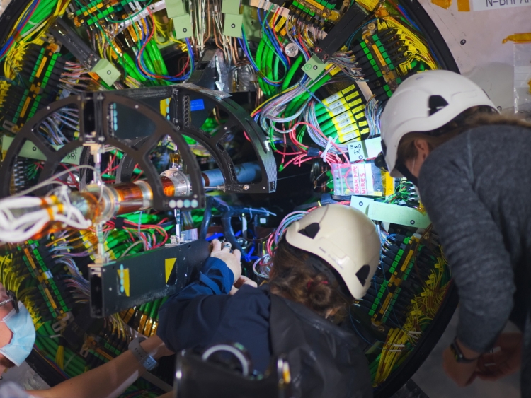 Axel Filenius (left), Anne Dabrowski (middle), and Joanna Wanczyk (right) work on the on the -Z side bulkhead. Credit: CERN, A.G. Delannoy
