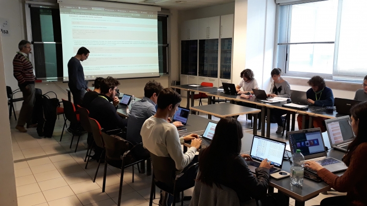 One of the parallel classes during the short exercises session. The students work hands-on on their laptops, while the facilitators explain the basics of data analysis.