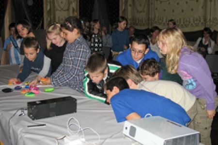 The children peering at the cosmic ray detector and playing with the particle pl